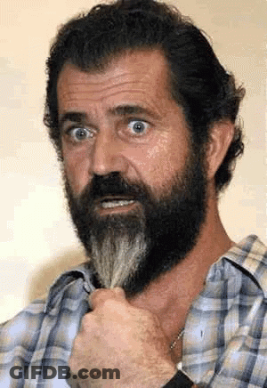 A Man With A Beard Is Wearing A Plaid Shirt And Holding His Beard GIF