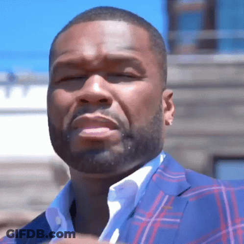 A Man With A Beard Is Wearing A Plaid Suit GIF