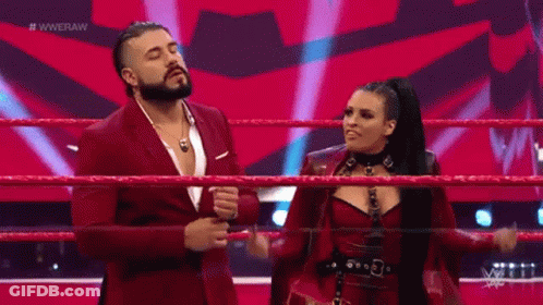 A Man With A Beard Is Wearing A Purple Suit And Giving A Thumbs Up Sign . GIF