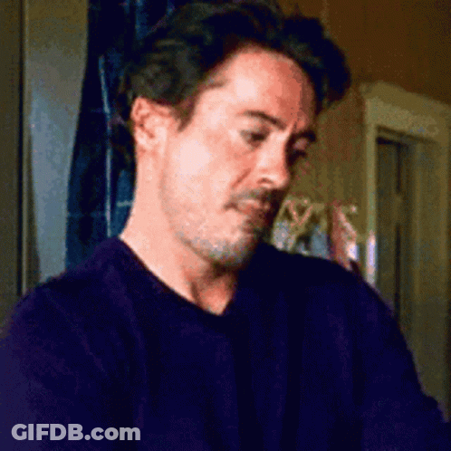 A Man With A Beard Is Wearing A Purple Sweater GIF