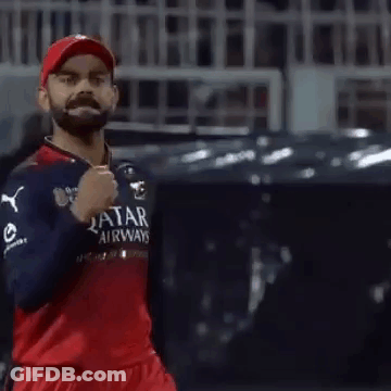 A Man With A Beard Is Wearing A Qatar Airways Jersey And A Red Hat . GIF
