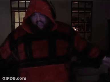 A Man With A Beard Is Wearing A Red And Black Jacket With The Letter H On The Front GIF