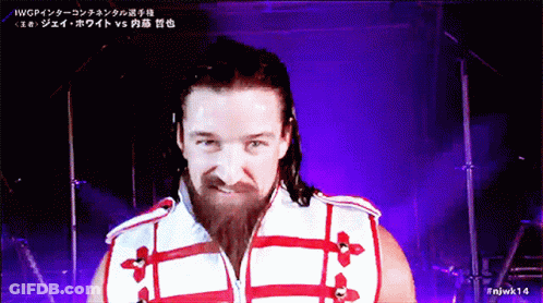 A Man With A Beard Is Wearing A Red And White Jacket GIF