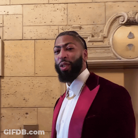 A Man With A Beard Is Wearing A Red Jacket And White Shirt GIF