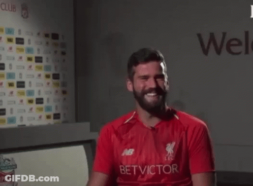 A Man With A Beard Is Wearing A Red Shirt That Says Bet Victor On It GIF