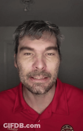 A Man With A Beard Is Wearing A Red Shirt That Says Go Fuck Yourself On It GIF