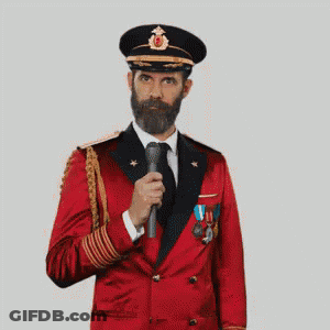 A Man With A Beard Is Wearing A Red Suit And Hat And Making A Funny Face . GIF