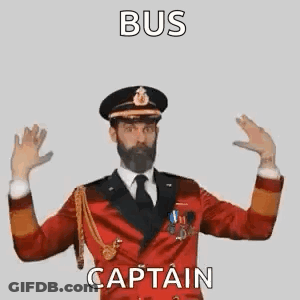A Man With A Beard Is Wearing A Red Suit And Tie And Making A Gesture With His Hands . GIF