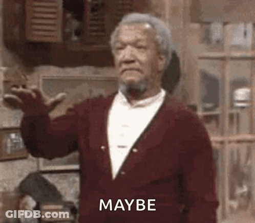 A Man With A Beard Is Wearing A Red Sweater And Making A Funny Face While Standing In A Room . GIF