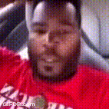 A Man With A Beard Is Wearing A Red T-Shirt That Says ' Miami ' On It . GIF