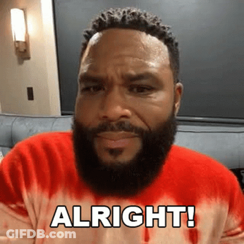 A Man With A Beard Is Wearing A Red Tie Dye Sweater And Saying Alright ! GIF