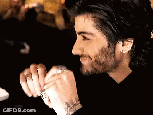 A Man With A Beard Is Wearing A Ring On His Finger GIF