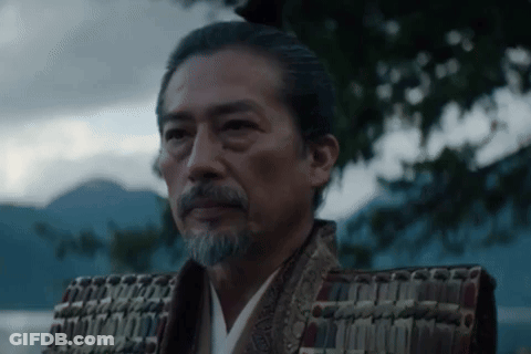 A Man With A Beard Is Wearing A Samurai Costume And Armor . GIF