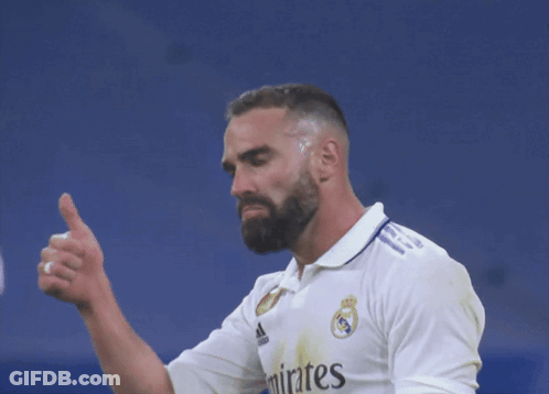 A Man With A Beard Is Wearing A Shirt That Says Emirates On It GIF