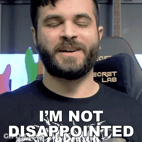 A Man With A Beard Is Wearing A Shirt That Says I 'M Not Disappointed GIF