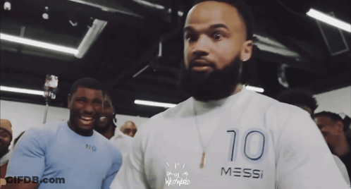A Man With A Beard Is Wearing A Shirt That Says Messi GIF