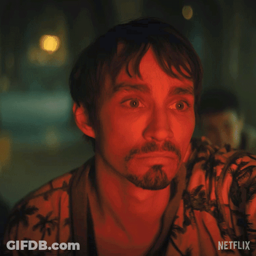 A Man With A Beard Is Wearing A Shirt That Says Netflix On The Bottom GIF