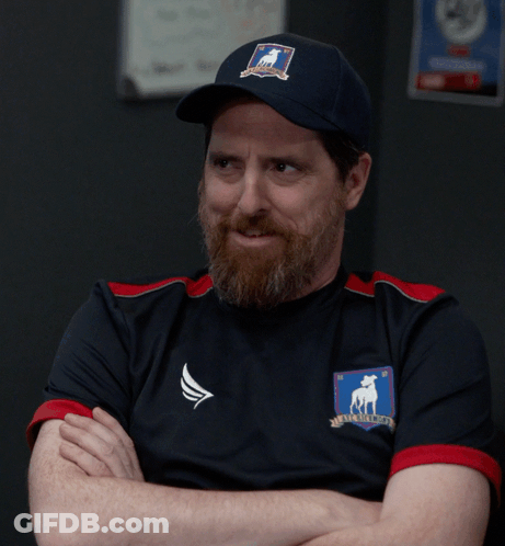 A Man With A Beard Is Wearing A Shirt That Says No On It GIF