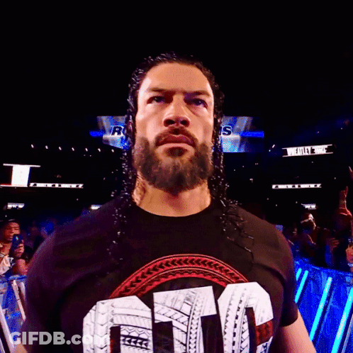 A Man With A Beard Is Wearing A Shirt That Says ' Smack Down ' On It GIF