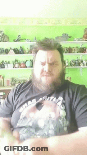 A Man With A Beard Is Wearing A Shirt That Says ' Smash Smith ' On It GIF