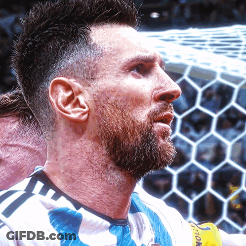 A Man With A Beard Is Wearing A Shirt That Says ' Soccer ' On It GIF