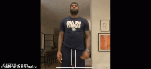A Man With A Beard Is Wearing A Shirt That Says ' Yjima ' On It GIF