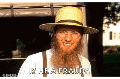 A Man With A Beard Is Wearing A Straw Hat And Suspenders . GIF