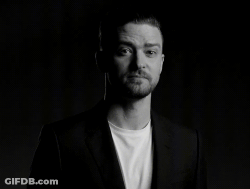 A Man With A Beard Is Wearing A Suit And A White Shirt GIF