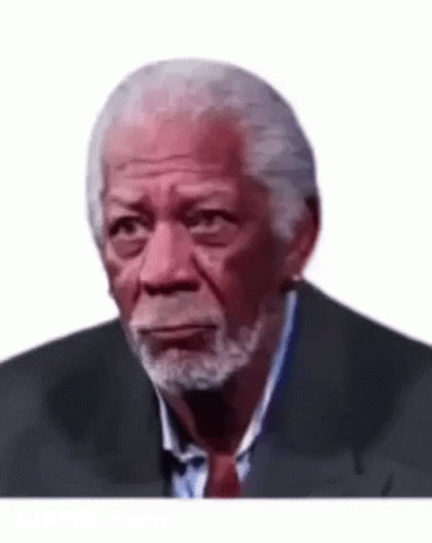 A Man With A Beard Is Wearing A Suit And Tie . GIF