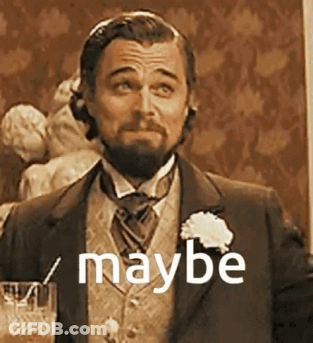 A Man With A Beard Is Wearing A Suit And Tie And Holding A Glass Of Wine . GIF