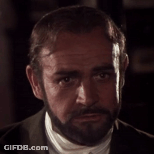 A Man With A Beard Is Wearing A Suit And White Shirt GIF