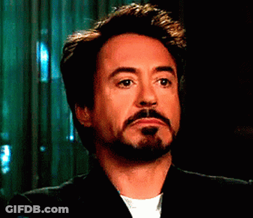 A Man With A Beard Is Wearing A Suit And White Shirt GIF