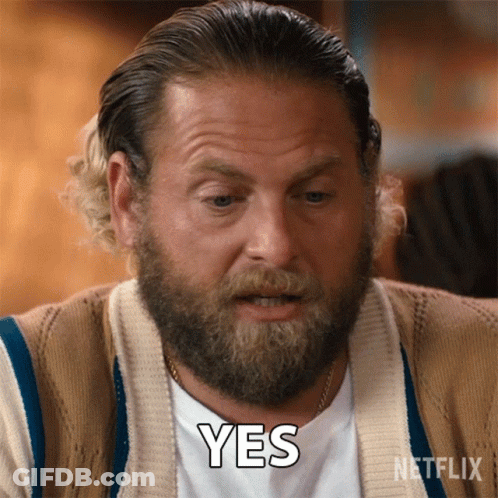 A Man With A Beard Is Wearing A Sweater And Says Yes GIF