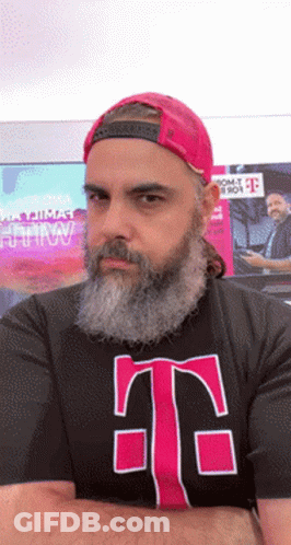 A Man With A Beard Is Wearing A T-Mobile T-Shirt GIF