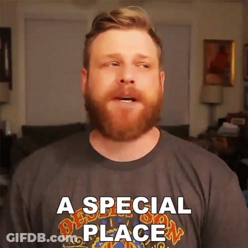 A Man With A Beard Is Wearing A T-Shirt That Says A Special Place GIF