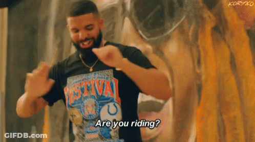 A Man With A Beard Is Wearing A T-Shirt That Says `` Are You Riding ? '' . GIF