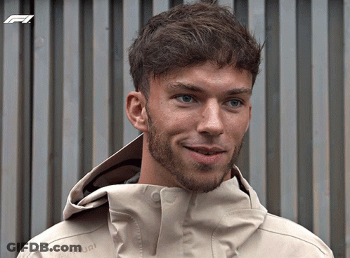 A Man With A Beard Is Wearing A Tan Jacket That Says Mammut On The Front GIF