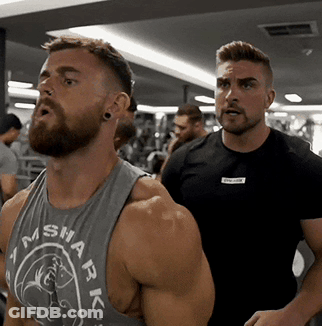 A Man With A Beard Is Wearing A Tank Top That Says Shark On It GIF
