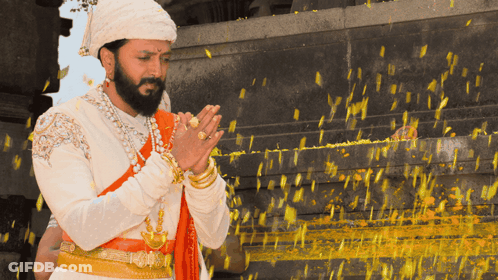A Man With A Beard Is Wearing A Turban And Praying With His Hands Folded GIF