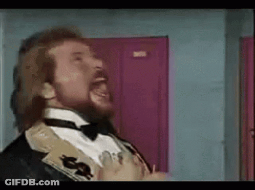 A Man With A Beard Is Wearing A Tuxedo And Bow Tie GIF
