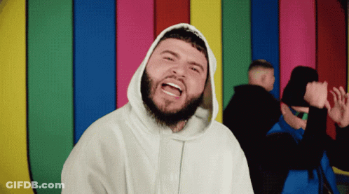 A Man With A Beard Is Wearing A White Hoodie That Says ' Supreme ' On It GIF