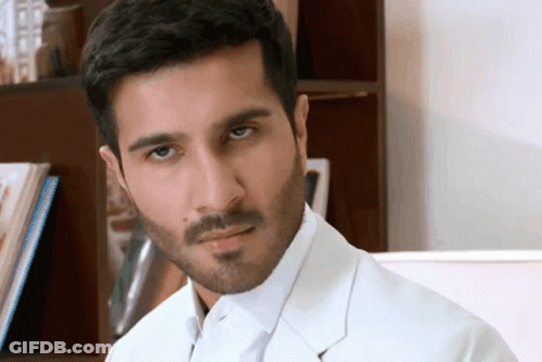 A Man With A Beard Is Wearing A White Jacket GIF
