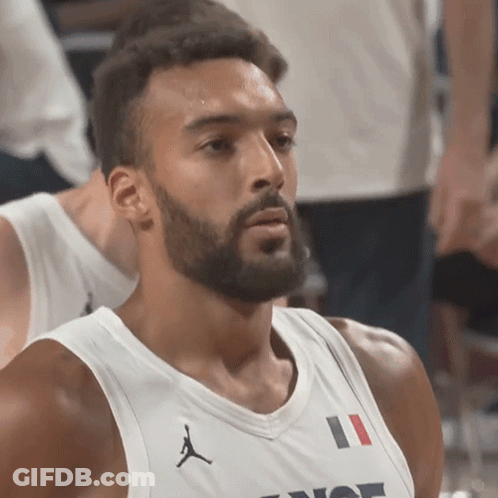 A Man With A Beard Is Wearing A White Jersey With The Number 11 On The Front GIF