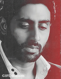 A Man With A Beard Is Wearing A White Shirt GIF