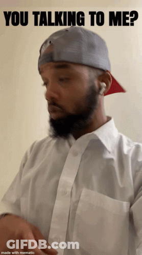 A Man With A Beard Is Wearing A White Shirt And A Gray Hat With The Words You Talking To Me Above Him GIF