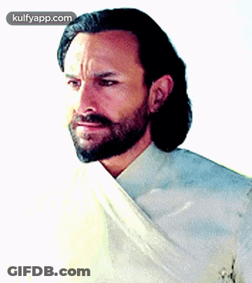 A Man With A Beard Is Wearing A White Shirt And A White Cloth Around His Neck GIF