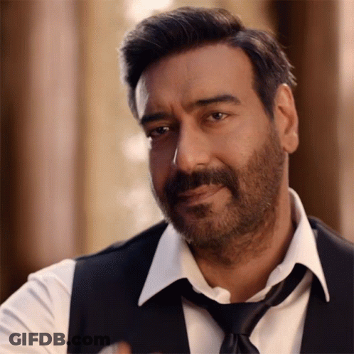 A Man With A Beard Is Wearing A White Shirt And Black Vest And Tie GIF
