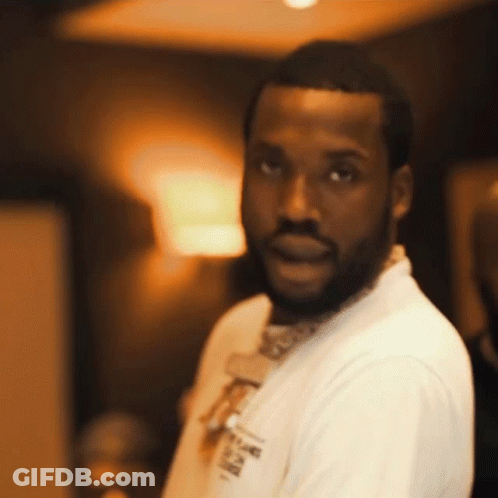 A Man With A Beard Is Wearing A White Shirt That Says ' A ' On It GIF