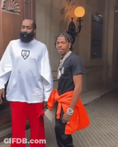 A Man With A Beard Is Wearing A White Shirt With A Logo On It GIF