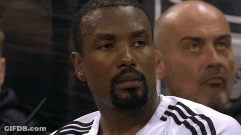 A Man With A Beard Is Wearing A White Shirt With Black Stripes GIF